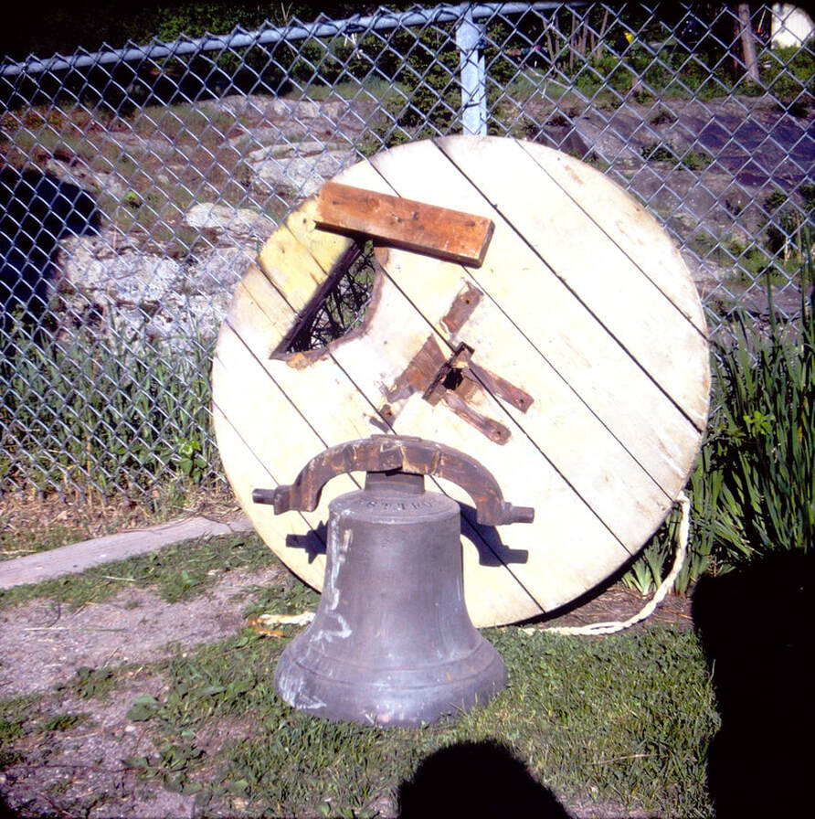 Picture: 33 – The bell originally in Barney’s woolen mill, which was across the river from the mill on water power #1. The bell was made in West Troy, NY. This was later used in the Underhill ID school in Underhill Flats for many years, and is now mounted outside of the second ID school building in Riverside, currently the home of the Chittenden East school offices. The bell first called workers to the mill, and later students to classes. Note the large wooden pulley which would attach to the left side of the bell, engaging the bracket on the bell, and the hole in this pulley so the flange of the bell would clear it. This was loaned to the historical society for display in the museum.